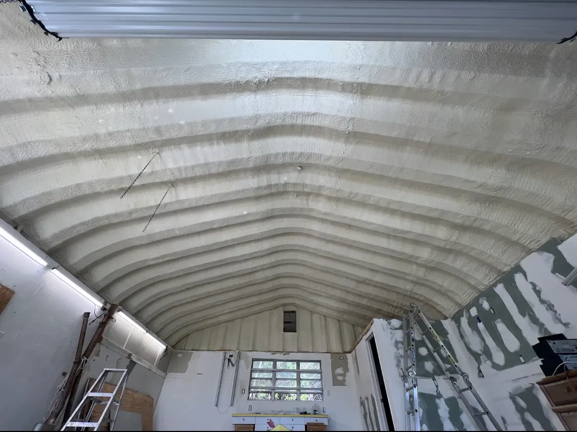 Spray polyurethane foam applied to the underside of a metal roof deck in Borger